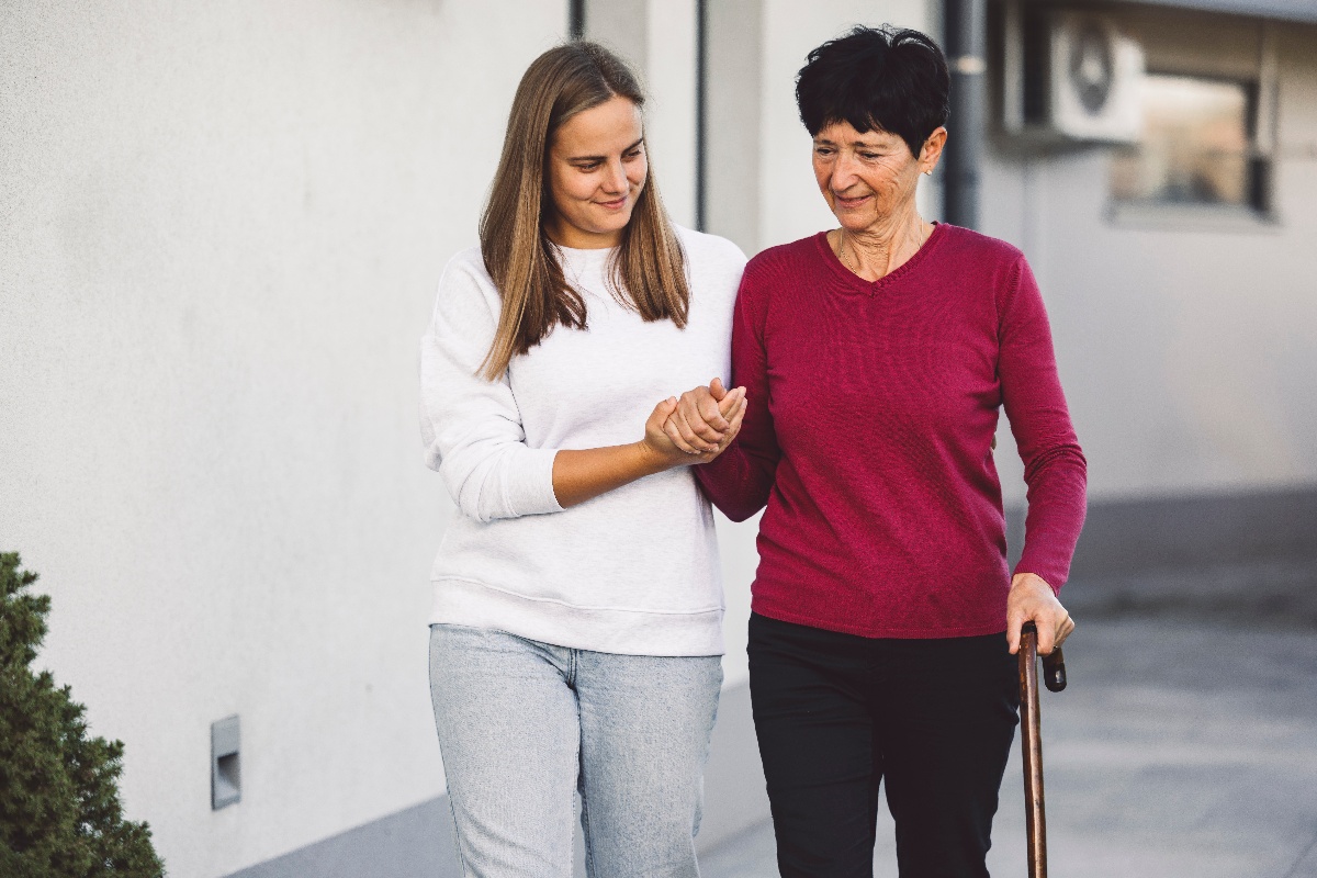 A social worker helps an elderly woman